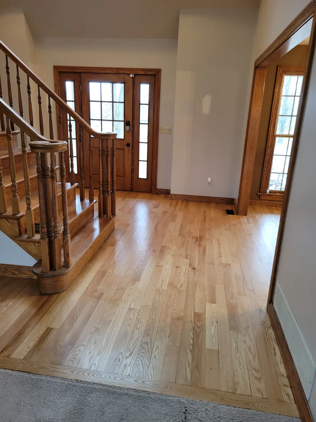 Red oak entry and staircase after board replacement and refinishing