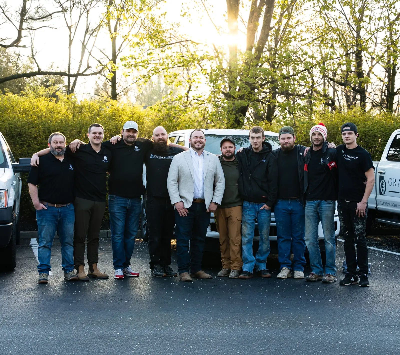 The Grain Design Flooring crew in front of their branded vans