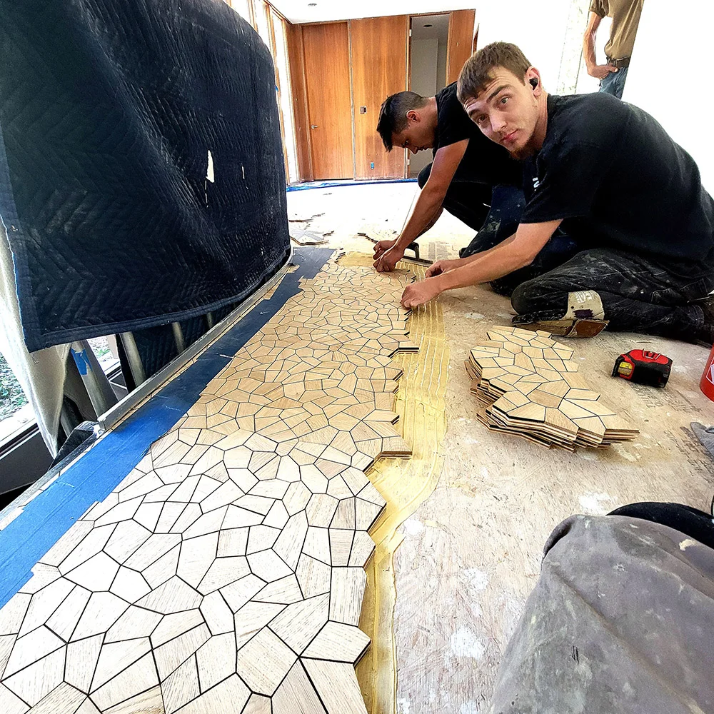 Grain Design installers hand-setting the interlocking oak tiles
